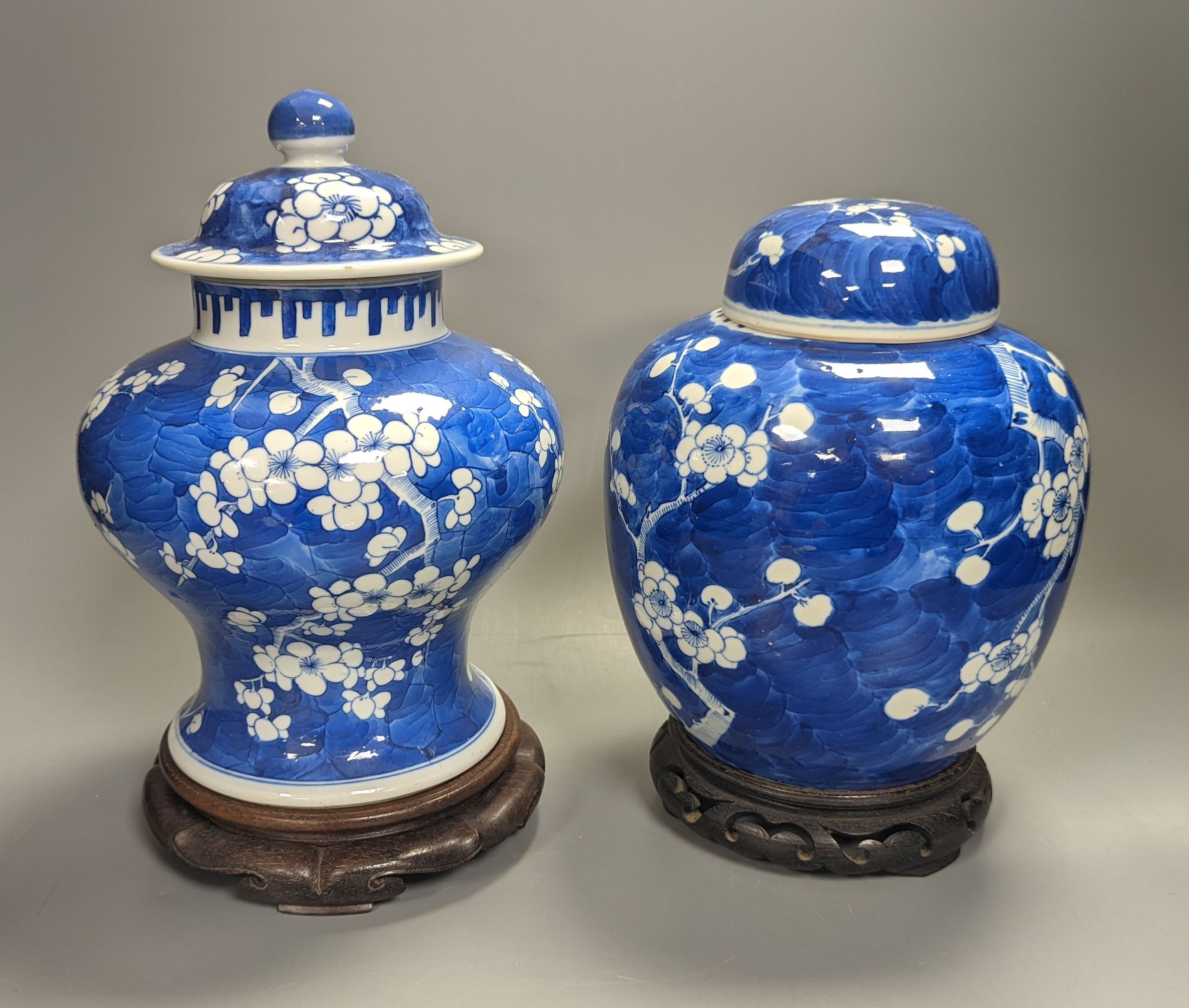 An 18th century Chinese blue and white prunus baluster jar and associated cover and a 19th century ginger jar, tallest 27cm incl. stand